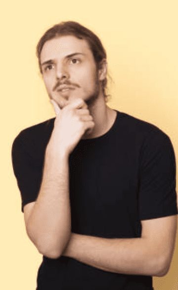 Seductive Storytelling: The Hypnotic Art Of Creating Irresistible Desire 69 Man Thoughtfully Holding His Chin, Representing Curiosity And Reflection About Seductive Storytelling Techniques.