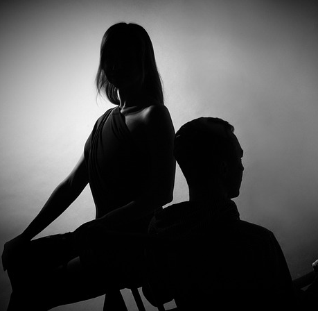 How To Seduce A Married Woman: A Masterclass In Emotional Connection And Influence 65 A Silhouetted Couple Sitting Back-To-Back, Symbolizing The Delicate Process Of Handling Emotional Conflicts With Empathy And Understanding.