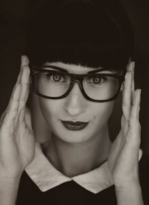 Signs She Is Crazy On Tinder: How To Avoid The Drama 45 Seductive Woman With Glasses Staring Intensely, Symbolizing Tinder Red Flags And Emotional Instability In Online Dating.