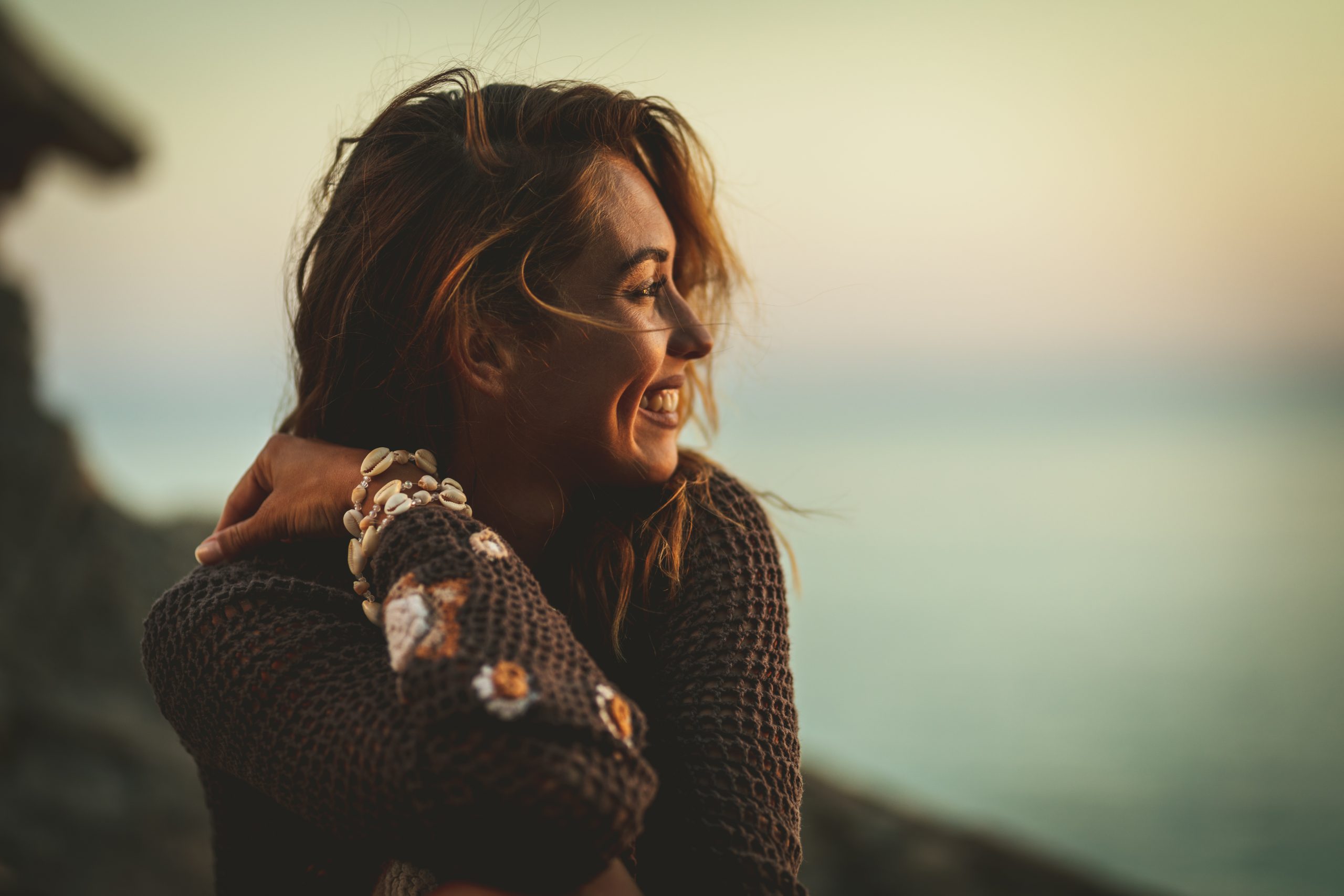 What Emotional Connection Really Means To Women - And How To Create It Fast 22 What Emotional Connection Really Means To Women - A Beautiful Young Pensive Woman Is Thinking And Relaxing On The Beach At The Sunset.