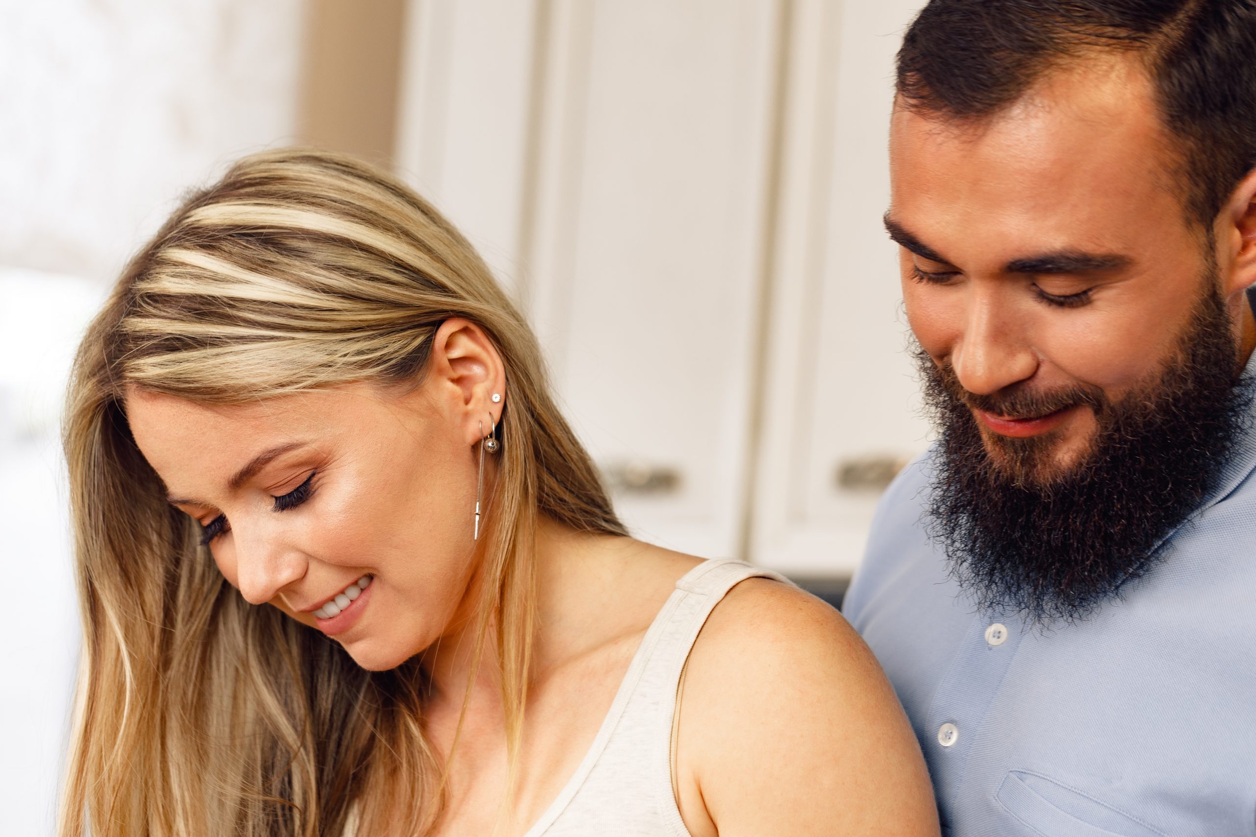 Why Qualifying Women Boosts Attraction - And How To Do It Naturally 25 Why Qualifying Women Boosts Attraction - Close Up Of Smiling Happy Couple Standing In Kitchen In Their Apartment