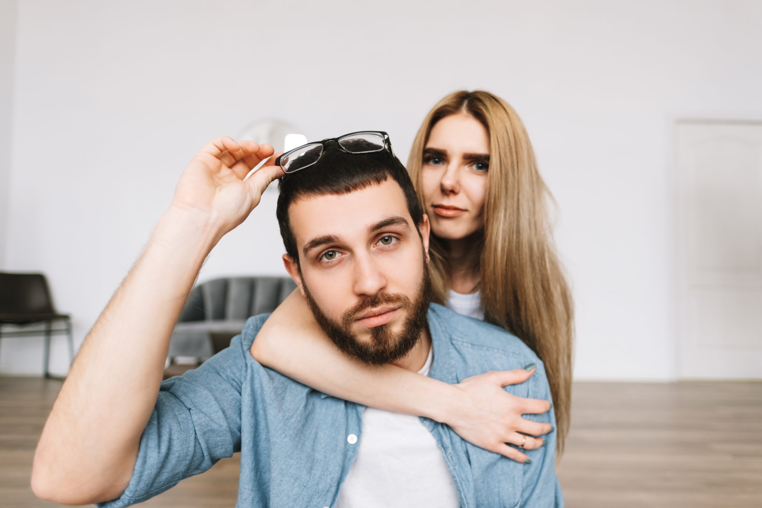 Nice Guy Behavior Patterns That Women Secretly Despise 22 Portrait Of Cheerful Couple Sitting On The Floor In New Apartment.