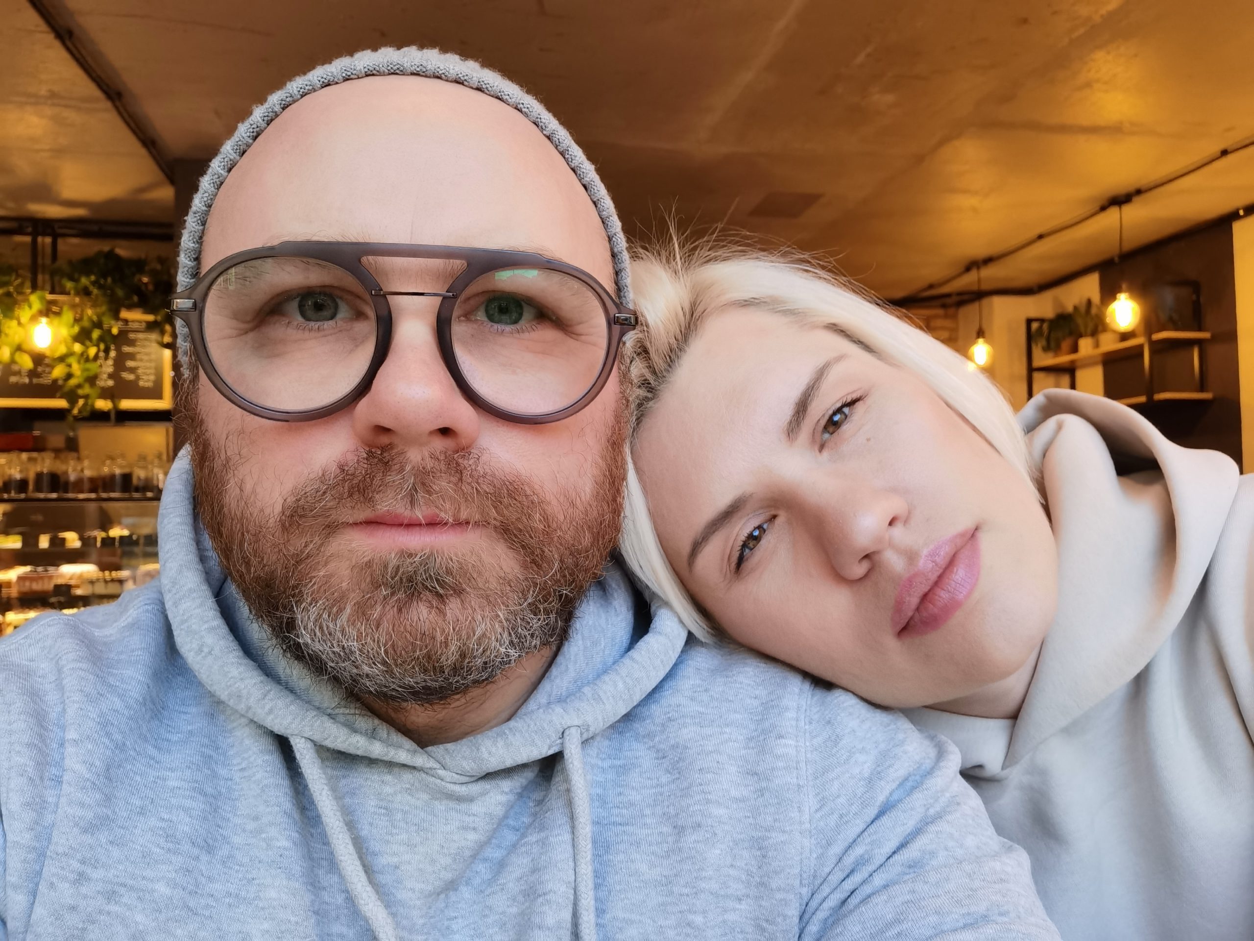 Why Beautiful Women Marry “Unattractive” Men: The Truth About Female Psychology 19 Why Beautiful Women Marry “Unattractive” Men - Romantic Couple Taking Selfie In Cafe. Young Attractive Man In Eyeglasses With Pretty Blond Woman. Restaurant Or Cafe