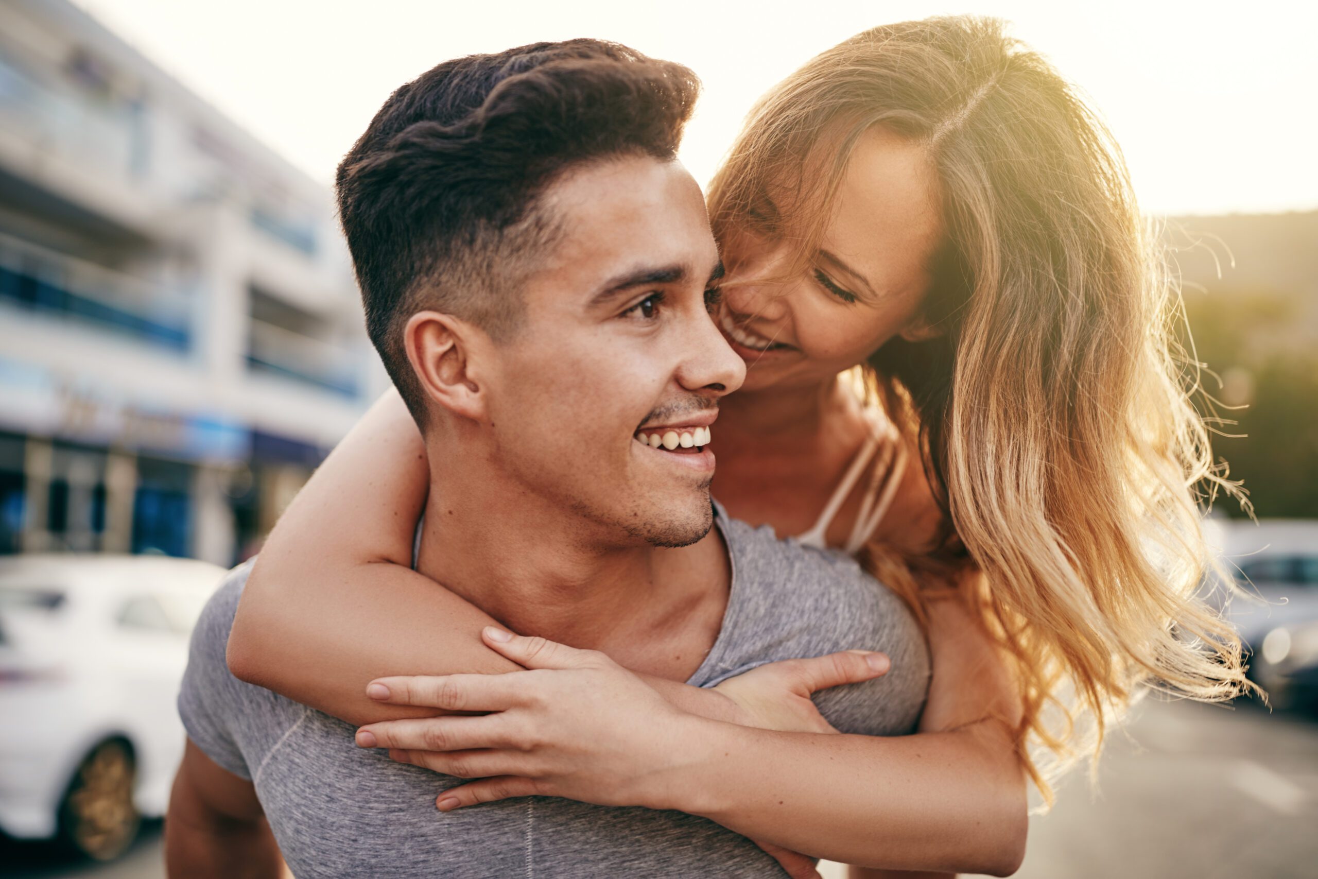 My Girlfriend Wants All My Time! How To Set Boundaries Without Losing Her 8 Smiling Young Man Giving His Laughing Girlfriend A Piggyback While Walking Together Down A Street In The City