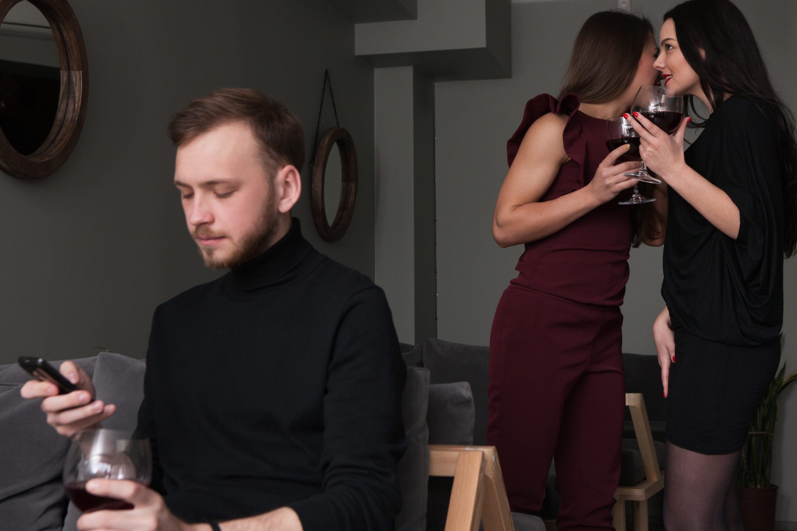 Can’t Get Women No Matter What You Do? Here'S The Brutal Truth (And What To Fix) 35 Female Gossips About Man. Party Celebration. Funny Women Conversation In Focus On Background. Thoughtful Male With Mobile Phone, Friendship Concept